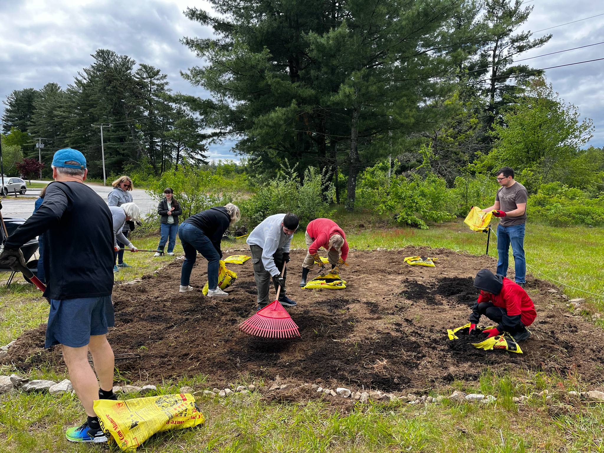 Members of the Laudato Si' Movement NH Chapter creating a pollinator garden.